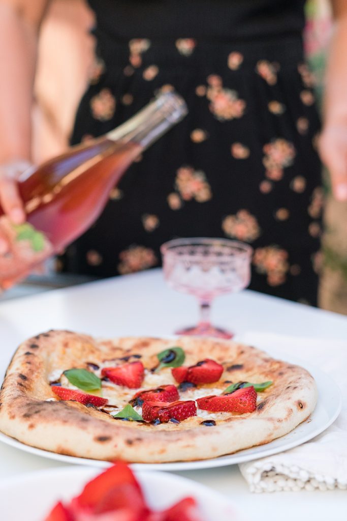 Strawberry pizza recipe and woman pouring wine